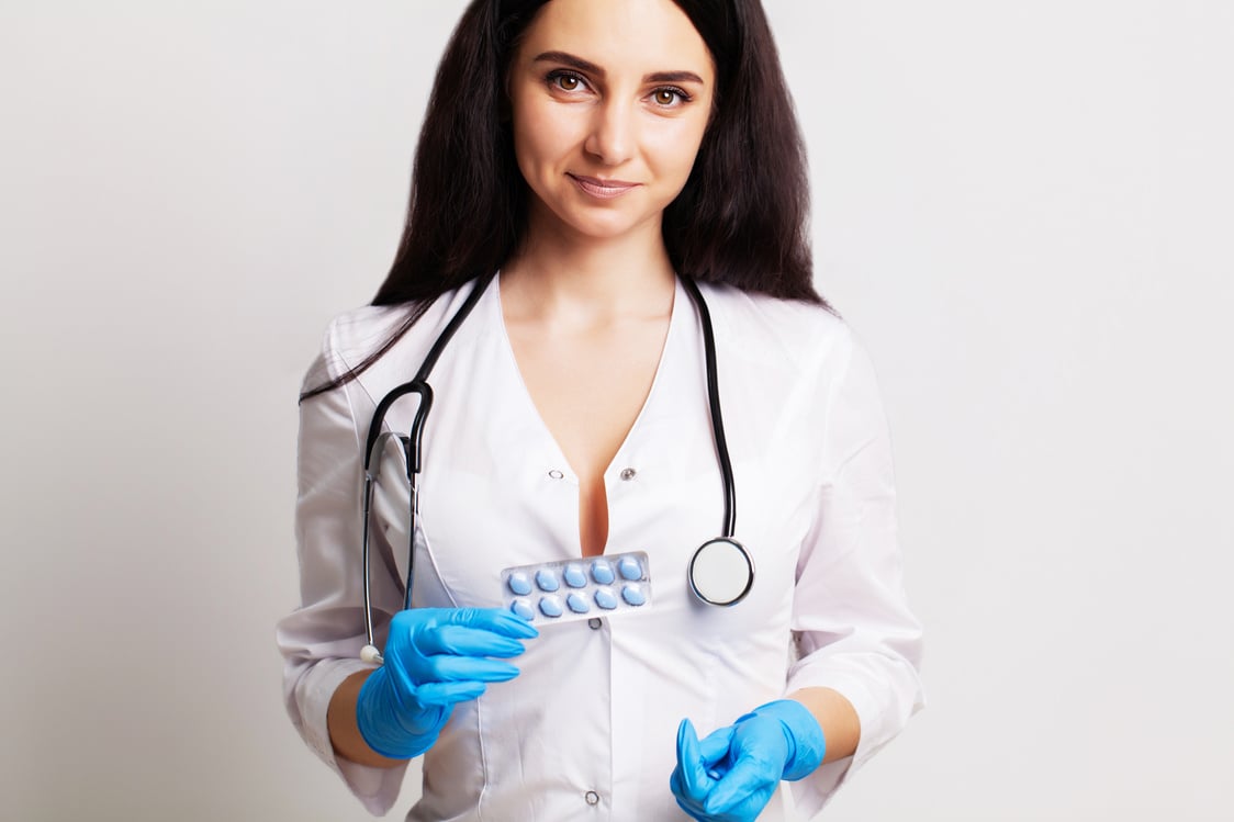 health, a doctor in a white coat holding a pill for a healthy  life of men